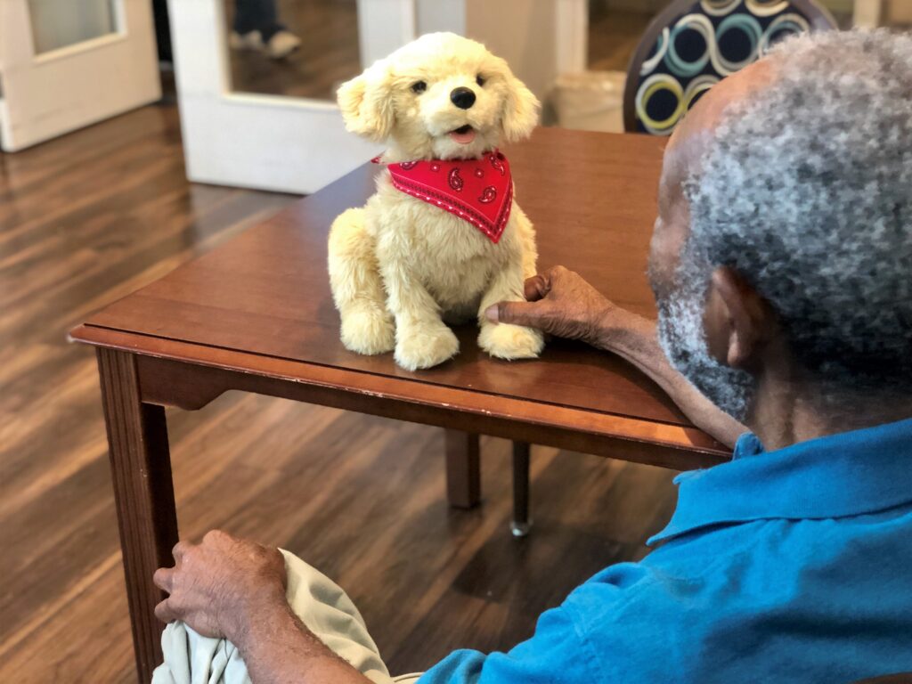Residents enjoy interacting with robotic companion pets and therapy animals at Cleveland House